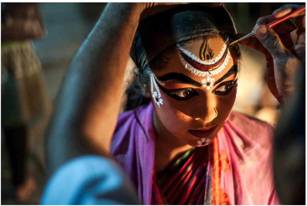 Female yakshagana performer getting her makeup done before a performance. Image Credit: Richa C. Bhavanam