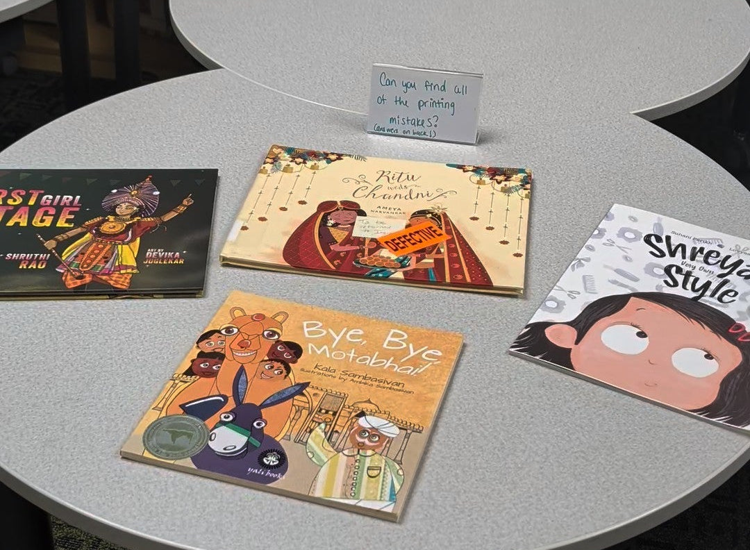 Children's books on a table in a library setting